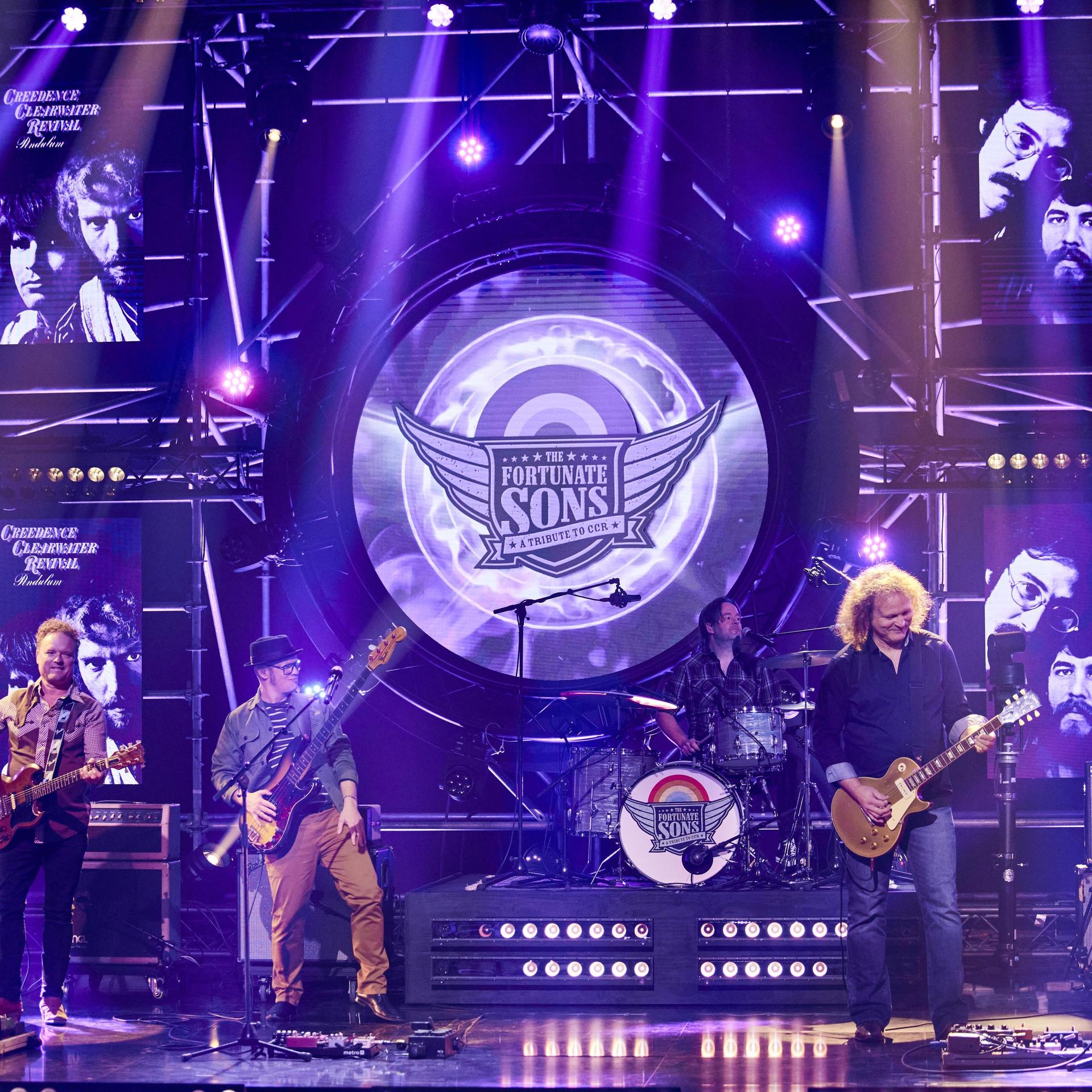 The Fortunate Sons, Promotiefoto van The Fortunate Sons - de band op het podium met paarse achtergrond
