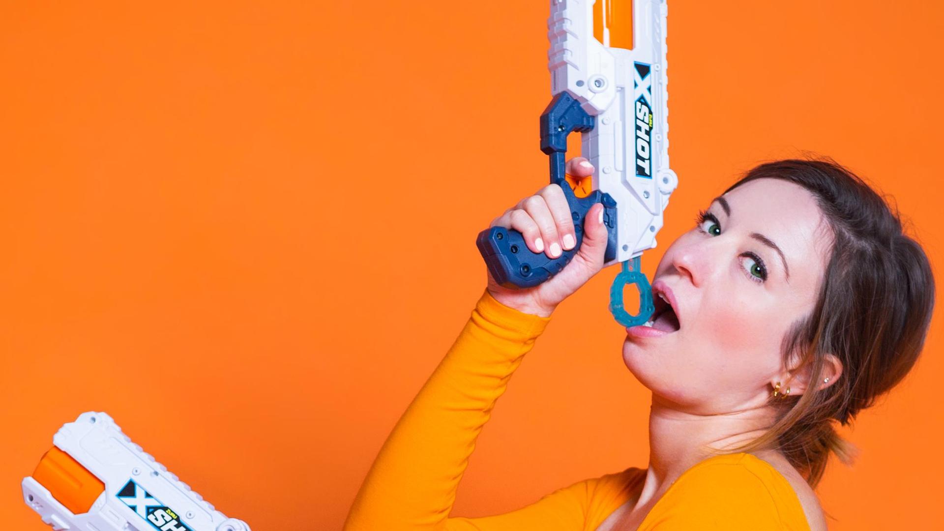 Anne Neuteboom, Foto van Anne Neuteboom met waterpistool tegen oranje achtergrond