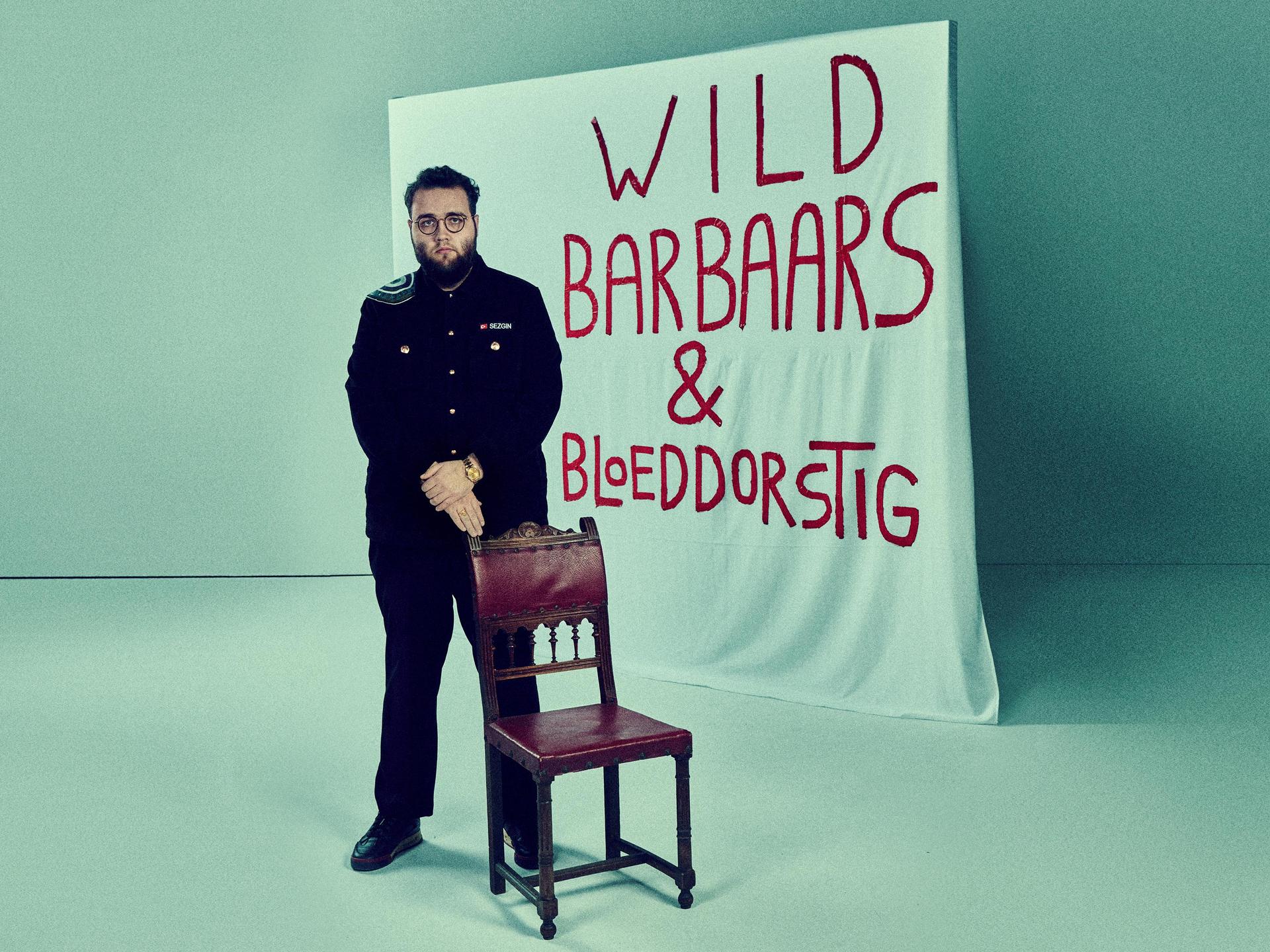 Sezgin Güleç , Promotiefoto van Sezgin Gulec met een doek achter hem met de titel Wild, Barbaars en Bloeddorstig