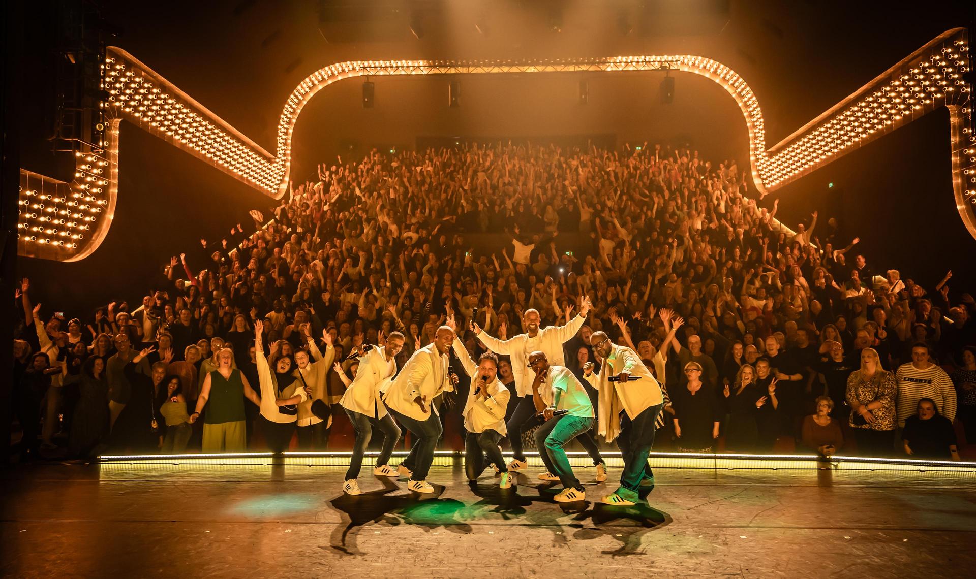 Foto van Re-Play en Romeo op het podium met publiek erachter